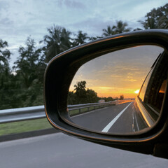 Obraz premium Side Mirror of car while driving 
