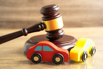 Hammer gavel judge with car vehicle accident, insurance coverage claim lawsuit court case.