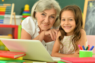 Close up portrait of happy grandmother and granddaughter