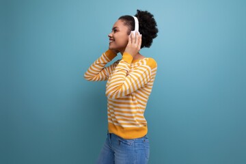 joyful afro brunette 20s latin young woman with headphones