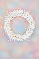 Cerithium sea snail shell and pearl wreath on rainbow sky cloud background. Summer nature abstract design for greeting card.