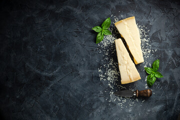 Hard cheese on a dark background, Hard cheese, place for text top view.