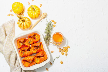 Oven baked pumpkin slices with honey, rosemary and seeds. Vegan food, trendy hard light, dark shadow