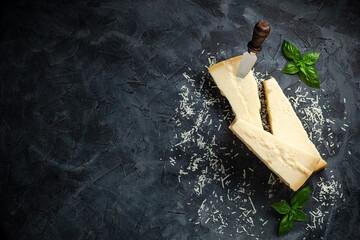 Hard cheese on a dark background, Hard cheese, place for text top view.