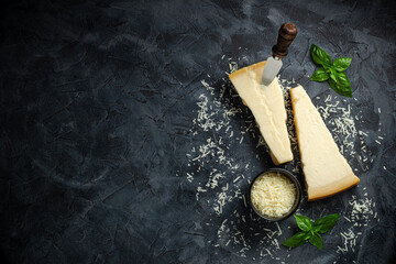 Hard cheese on a dark background, Hard cheese, place for text top view.