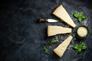 Parmesan cheese. Hard cheese on a dark background. banner, menu, recipe place for text, top view.