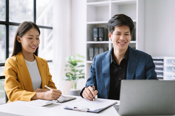 Fototapeta premium Businessmen team or financial data analysts working with tablets and laptop computers and data graphs together. Plan to analyzing projects in the office.