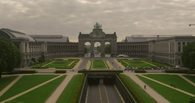 Establishing shot city of Brussels, Belgium. The Cinquantenaire memorial arch at the Parc du Cinquantenaire. Busy road, highway in the middle of the park. Traffic movement