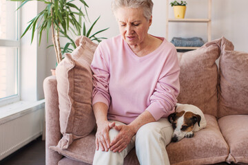 senior woman suffering from pain in leg