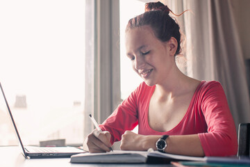 Obraz premium Millennial student sit at desk study on laptop