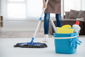 Woman, housewife mopping floor at home.