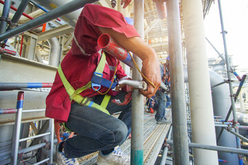 Workers installing scaffolding at construction site