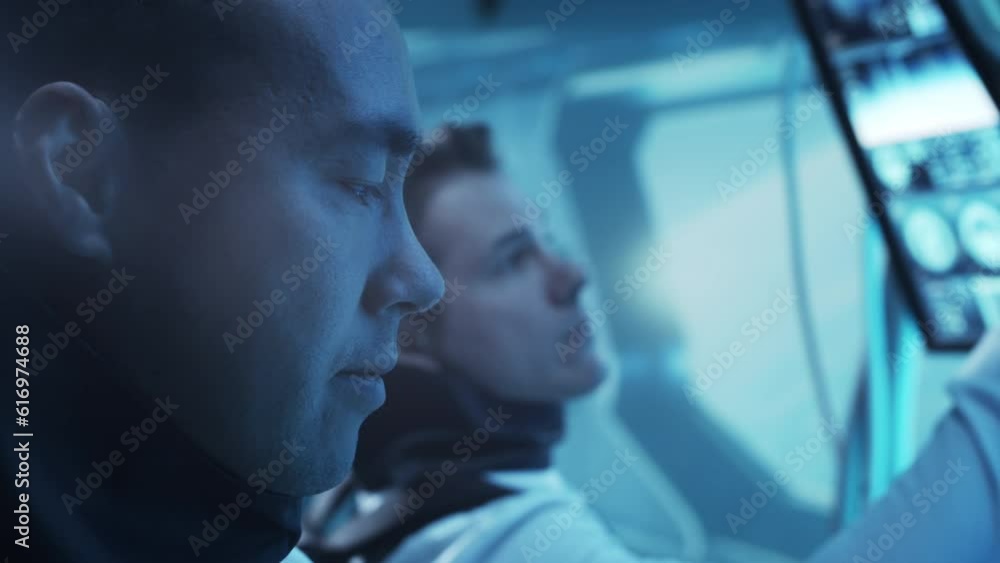 Wall mural team of astronauts in a space suits aboard the orbital station. a crew of cosmonauts piloting the sp