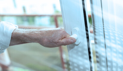 Hand opening a window; light effect