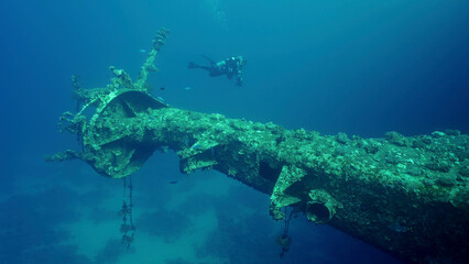 Scuba diver swim next to mast of ferry Salem Express shipwreck, Red sea, Safaga, Egypt