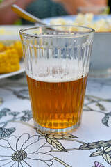 half full glass of beer on table outdoors