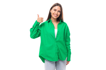 young european brown-eyed female model with well-groomed black hair and make-up dressed in a green shirt isolated on white background with copy space