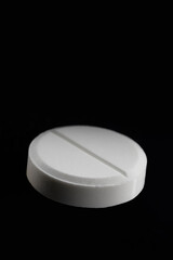 Pharmacy healthcare and drug concept. Macro shot up of white tablet hanging in the air on black background with copyspace