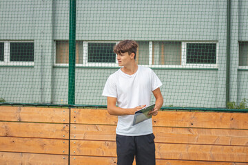 Young, ambitious coach instructs his players on what to do on the field. Coaching games from behind...