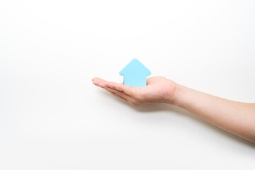 paper house on hand on white background, family house concept, family day care, real estate, housing and mortgage,foster home care or family day care, home minimal style.