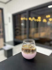Strawberry milk coffee in a glass inside the cafe