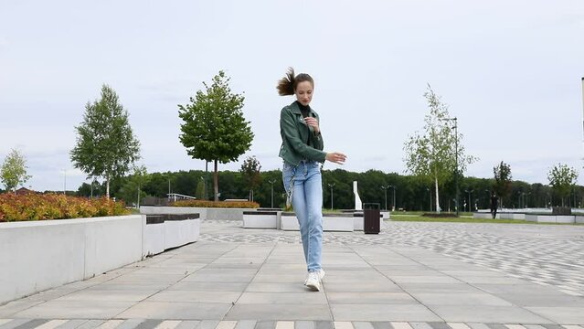 Shuffle dencer. Young beautiful girl dancing modern dance on the street