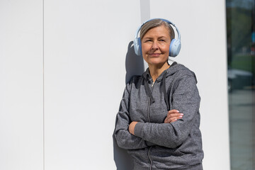 Woman in headphones listening to podcast and looking involved