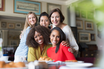 Portrait smiling women friends dining at restaurant table