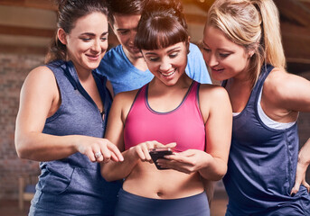Young women and man in sports clothing texting with cell phone