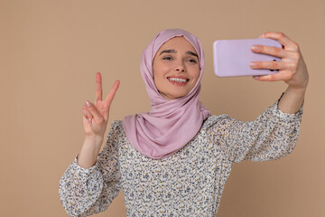 Happy young woman making selfie and smiling