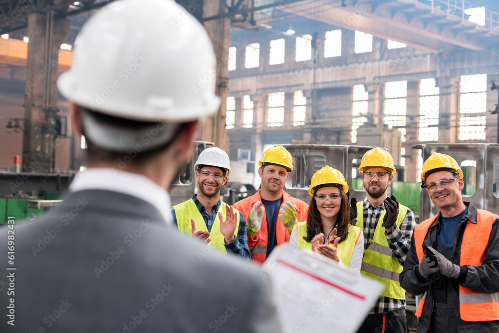 Poster Steel workers clapping for manager in meeting in factory