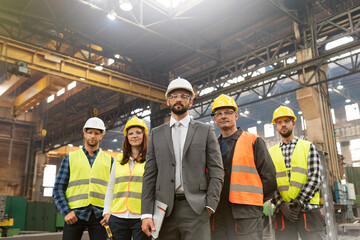 Portrait confident manager and steel worker team in factory - obrazy, fototapety, plakaty