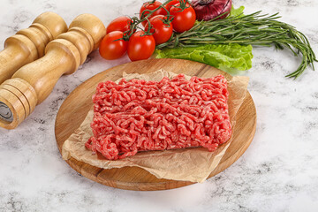 Raw minced beef meat on cutting board