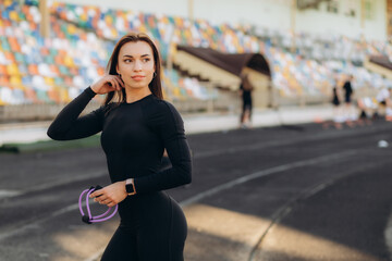 Fototapeta na wymiar Woman Stretching And Warming-Up Arms Before Running. Fit sport woman stretching her body warm up standing on Running track start line ready jogging. Athletic woman prepare for running training