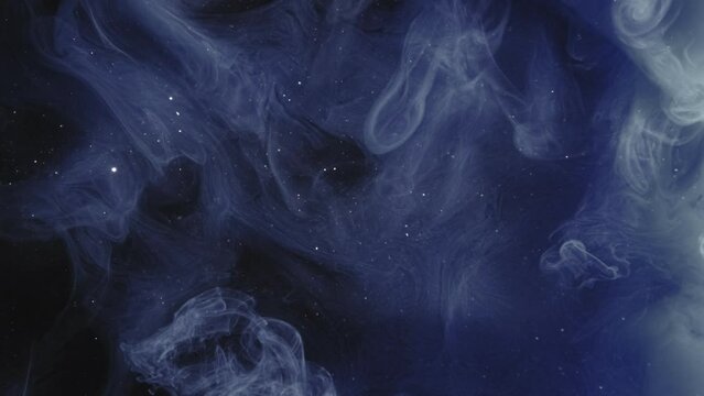 Paint splash. Star cloud. Ink water. Magic night sky. Blue color glitter dust particles mist spreading motion on dark abstract art opener background.
