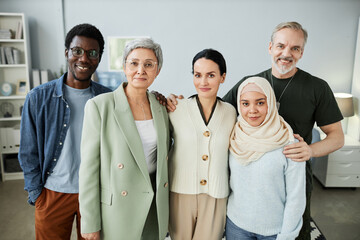 Group of intercultural patients of psychological course in casualwear and mature female counselor...