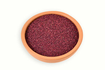 Obraz na płótnie Canvas Dried Organic Beetroot small pieces on clay pot, isolated on white. copy space. top view. Heap of beetroot powder on white background, view from above. dehydrated beetroot granules on white background
