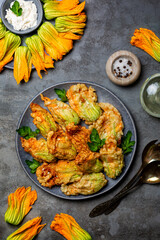 Fried in a batter Zucchini Flowers stuffed with ricotta cheese and parsley. Roasted courgette or...