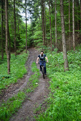 man on a mountain bike in the forest