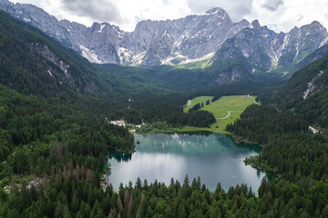 Obraz na płótnie Canvas Fusine Lake in Italy with Alps mountains in background , Europe. Aerial drone view.