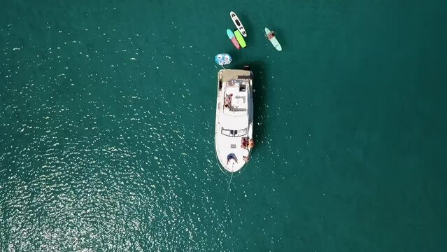 Boat with surfboards, filmed with a drone