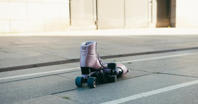Roller skates outdoors on urban street. Rollerblading hobby on sunny day
