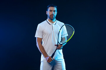 Squash player on a squash court with racket. Man athlete with racket on court with neon colors....