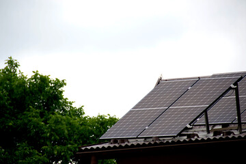 Installing a Solar Cell on a Roof. Solar panels on roof. Historic farm house with modern solar panels on roof and wall. High quality photo