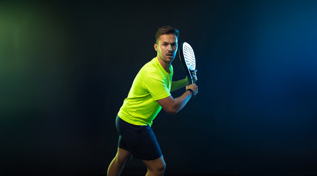 Padel Tennis Player with Racket in Hands. Paddle tenis, on a black background. Download in high resolution picture for magazine cover.