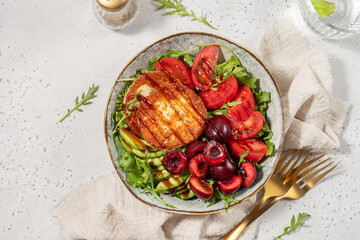 grilled Halloumi cheese, cherry, tomatoes, avocado, and arugula. Vegan food Diet menu. Top view. Flat lay.
