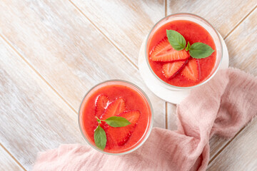 Italian dessert panna cotta in glass with strawberries.