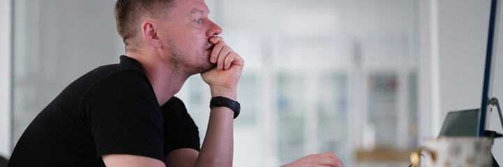 Fototapeta premium Male freelancer working on computer at home. Work online concept