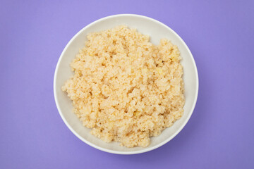 Tasty fresh boiled quinoa in white bowl