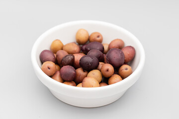 many salted mixed olives in white bowl